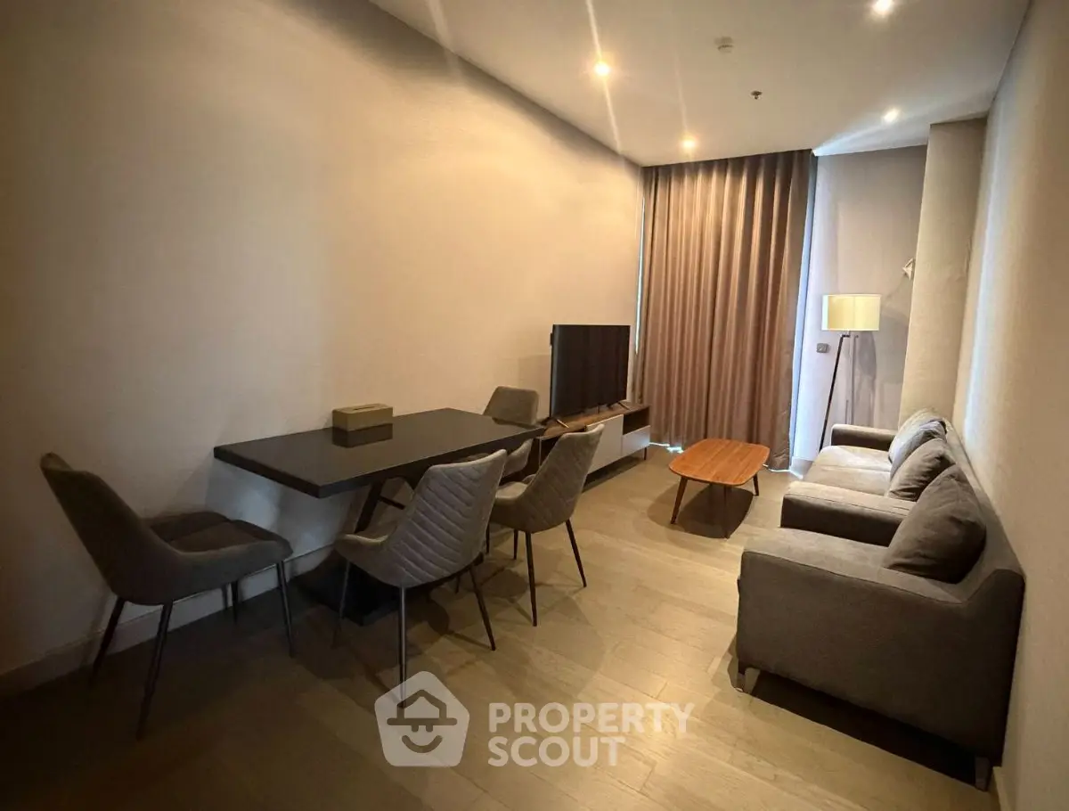 Modern living room with sleek furniture and ambient lighting in a stylish apartment.