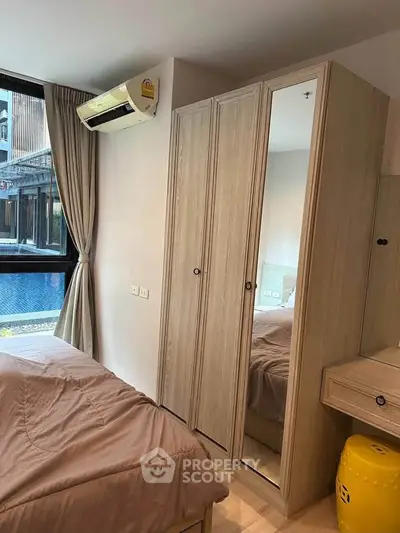 Cozy bedroom with pool view, featuring mirrored wardrobe and air conditioning for comfort.