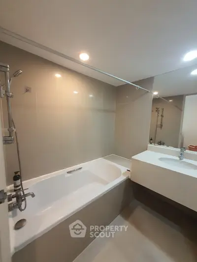 Modern bathroom with sleek bathtub and elegant fixtures in a contemporary apartment.