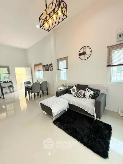 Modern living room with stylish decor and open dining area