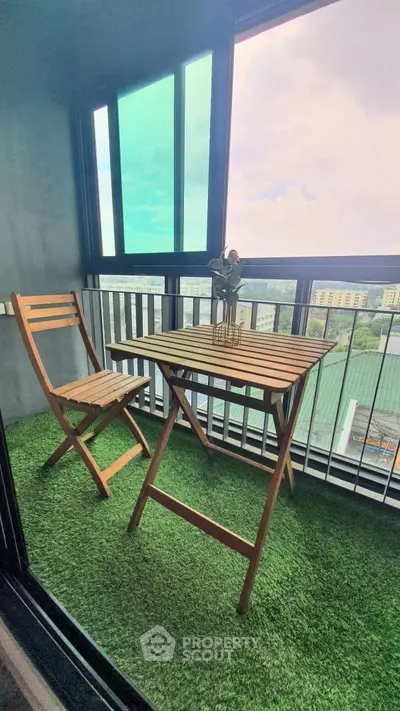 Charming balcony with wooden furniture and artificial grass overlooking cityscape.