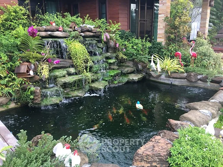 Stunning garden with waterfall and koi pond, perfect for serene outdoor living.