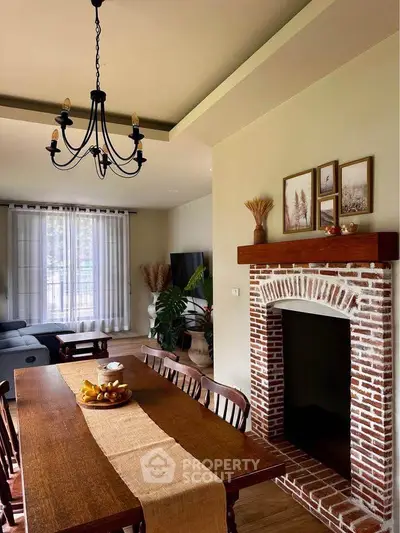 Charming living room with rustic brick fireplace and elegant dining area