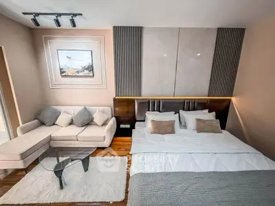 Luxurious modern bedroom with elegant decor and cozy seating area