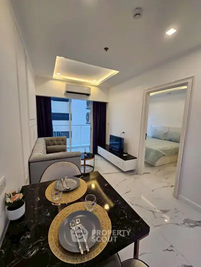 Modern living room with elegant dining area and cozy bedroom in open layout apartment.
