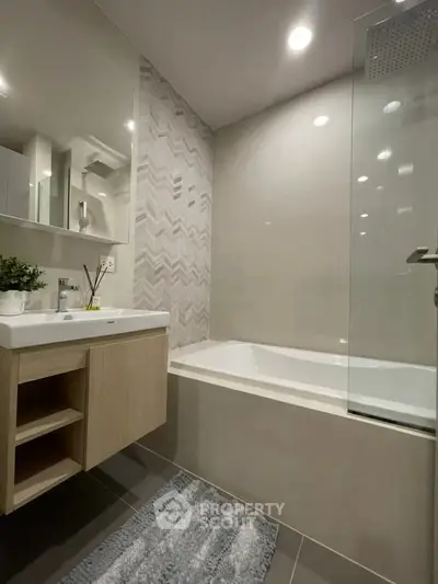 Modern bathroom with sleek design, featuring a bathtub and stylish vanity in a contemporary apartment.