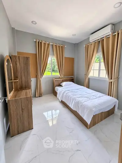 Bright and cozy bedroom with modern furnishings and natural light