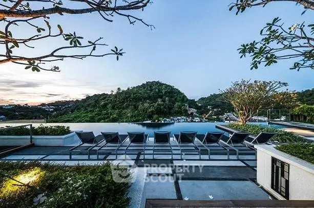 Luxurious infinity pool with stunning mountain view at sunset