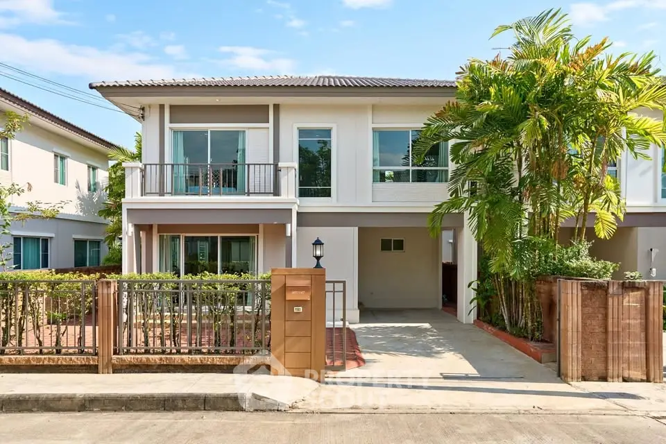 Modern two-story house with lush greenery and spacious driveway