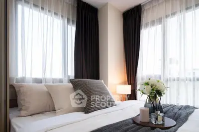 Elegant bedroom with large windows and stylish decor in modern apartment