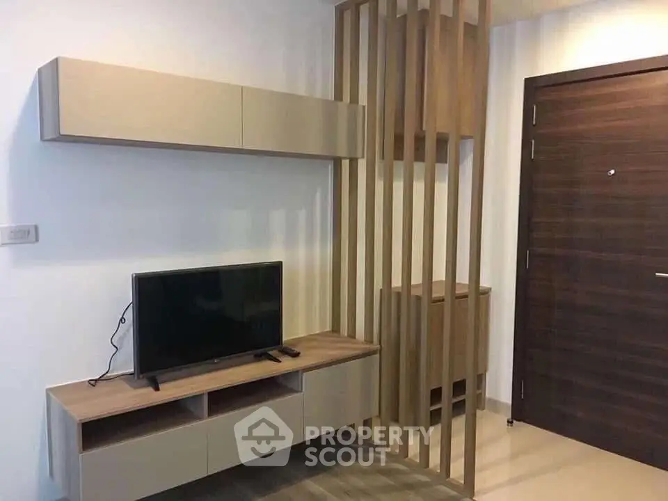 Modern living room with sleek TV stand and wooden partition