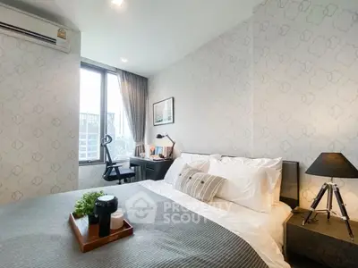 Modern bedroom with stylish decor and natural light, featuring a cozy bed and work desk by the window.