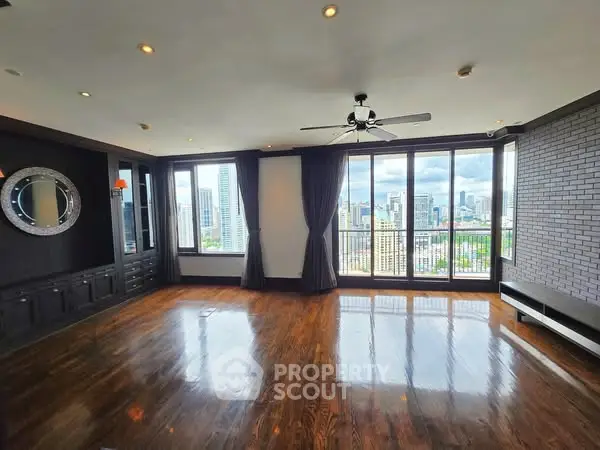 Spacious living room with city view and large windows in modern apartment