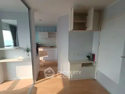 Bright and modern apartment interior with open kitchen and ample storage space.