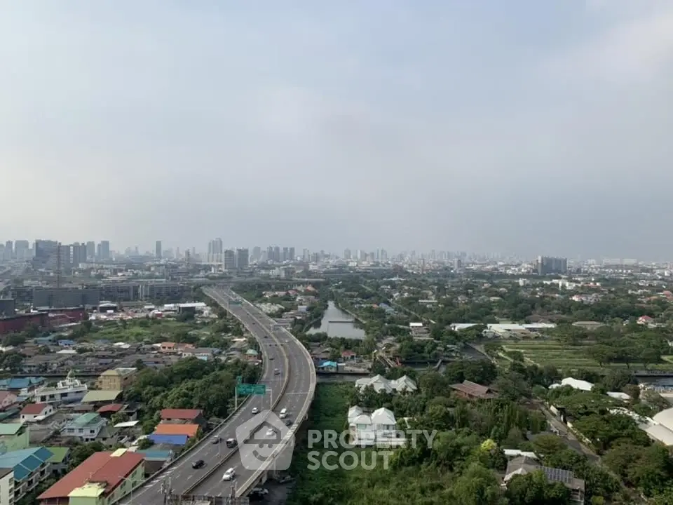 Stunning cityscape view showcasing urban skyline and lush greenery, perfect for real estate investment.