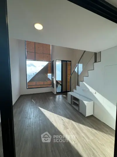 Modern duplex living room with high ceiling and large windows