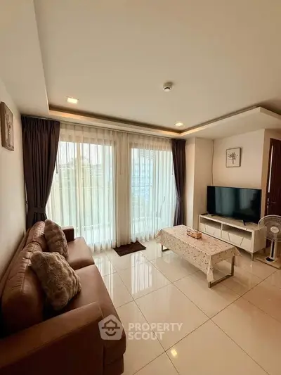 Spacious living room with modern decor and large windows for natural light.