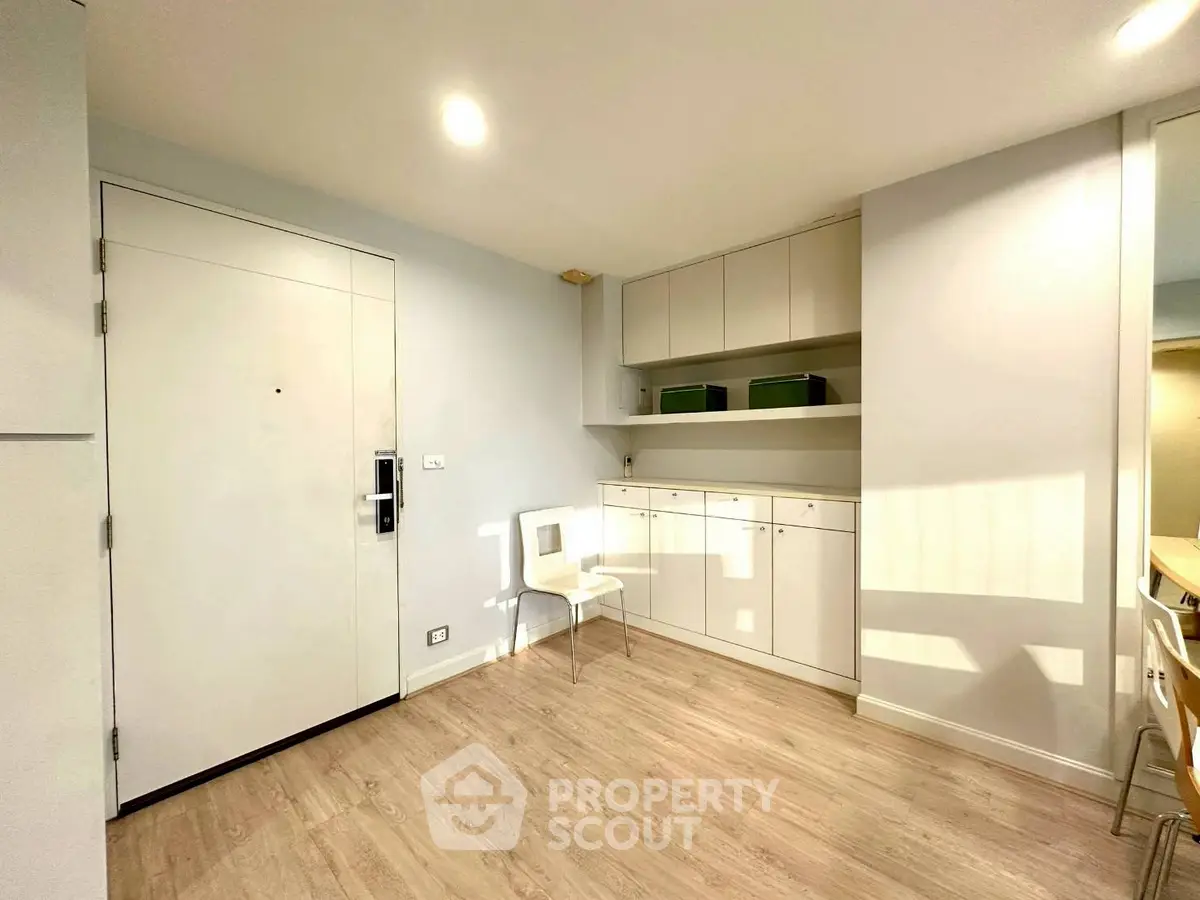 Modern minimalist interior with sleek cabinetry and light wood flooring