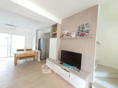 Modern living room with open layout, stylish furniture, and natural light, perfect for contemporary living.