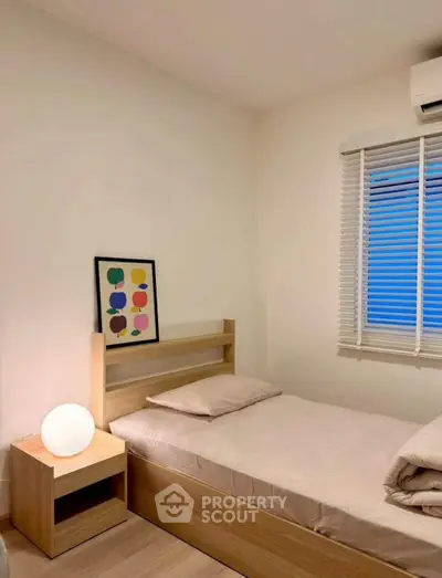 Cozy minimalist bedroom with single bed and modern decor