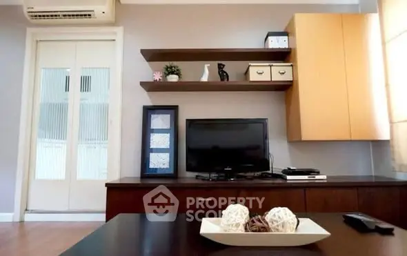 Modern living room with TV, shelves, and stylish decor