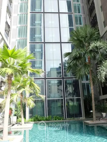 Luxurious condominium with stunning pool and lush palm trees