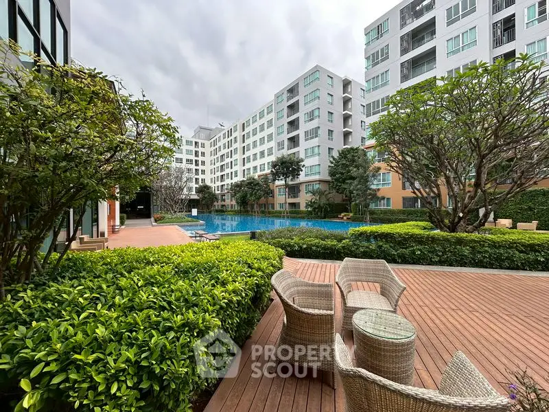 Luxurious apartment complex with pool and lush garden view