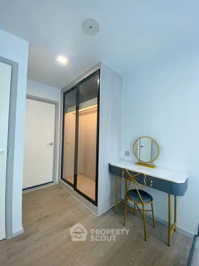 Modern bedroom with stylish vanity and walk-in closet
