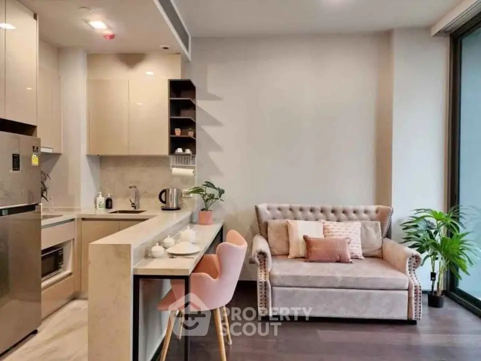 Modern living room with cozy sofa and stylish kitchen in open layout apartment.