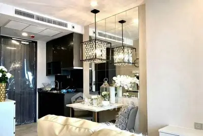 Luxurious modern living room with elegant dining area and stylish kitchen in open layout apartment.