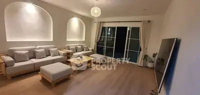 Spacious modern living room with elegant decor and large TV