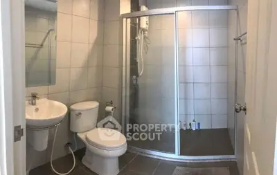 Modern bathroom with glass shower and sleek fixtures in a contemporary home.