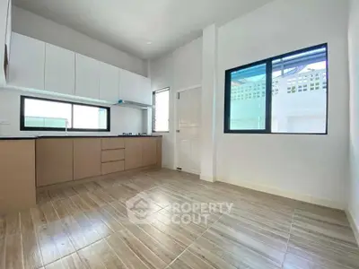 Modern kitchen with sleek cabinetry and gas stove in bright, airy space.