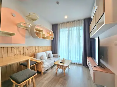 Modern living room with stylish furniture and large window for natural light.