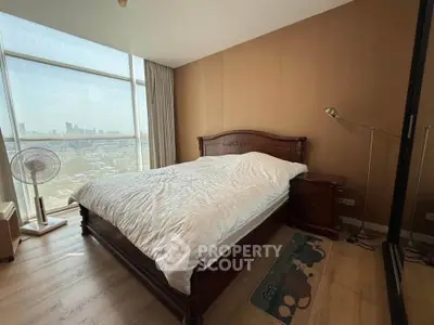 Spacious bedroom with city view and elegant wooden furniture