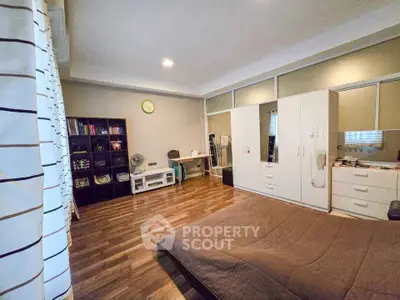 Spacious bedroom with modern decor and ample storage space