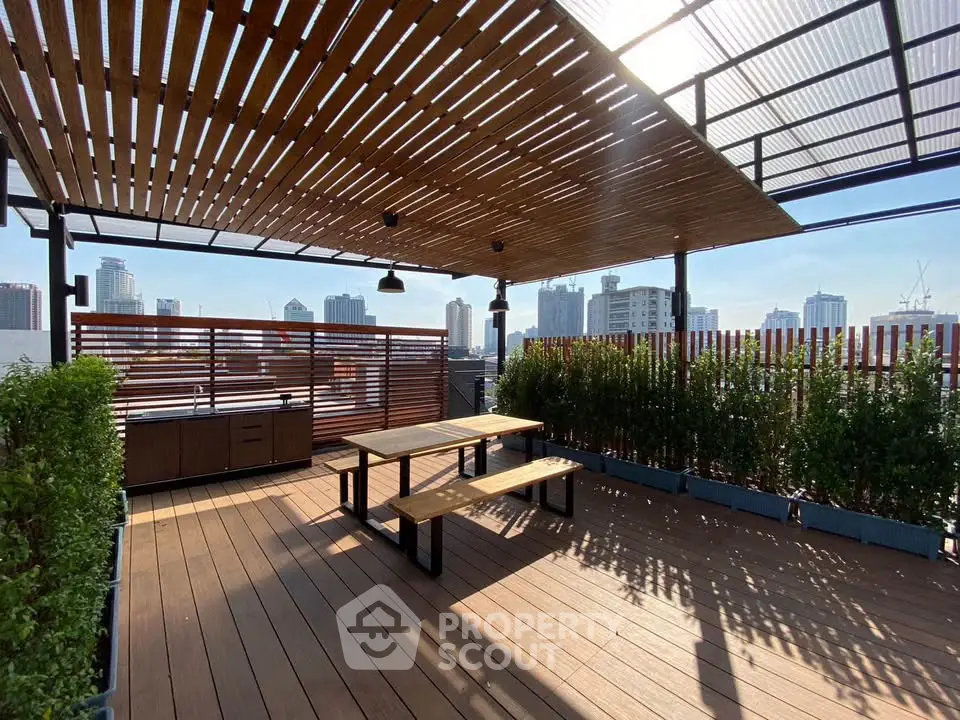 Stunning rooftop terrace with wooden deck and city skyline views, perfect for outdoor gatherings.