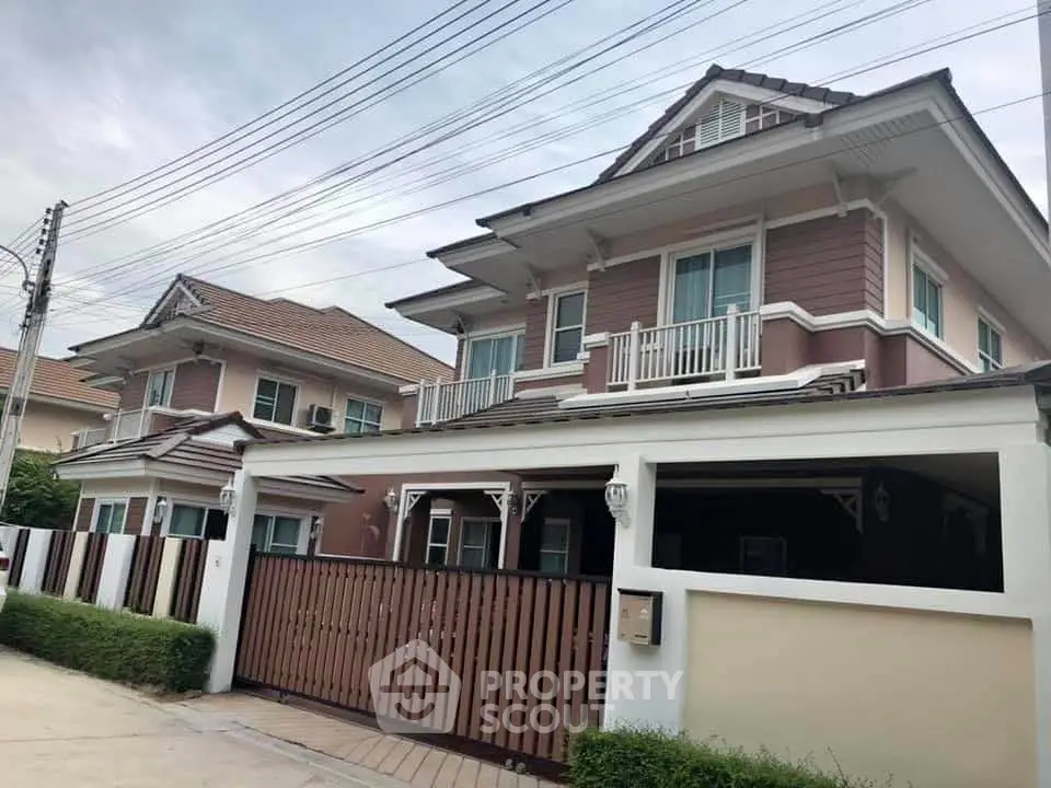 Elegant two-story house with modern design and spacious driveway in suburban neighborhood.
