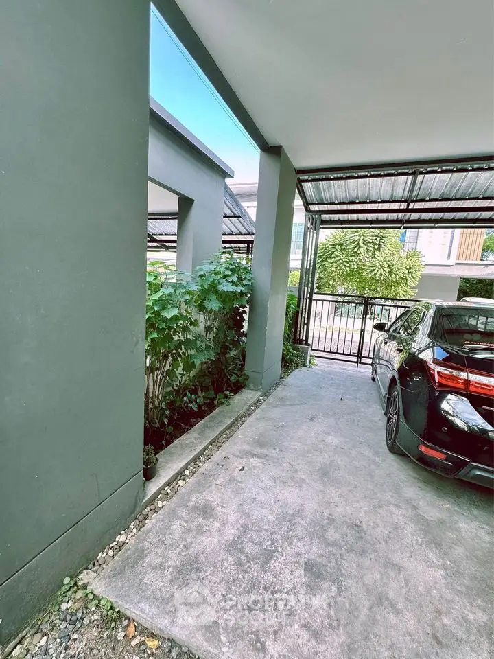 Modern carport with sleek design and lush greenery