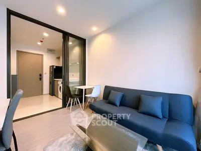 Modern living room with sleek furniture and glass coffee table in a stylish apartment.