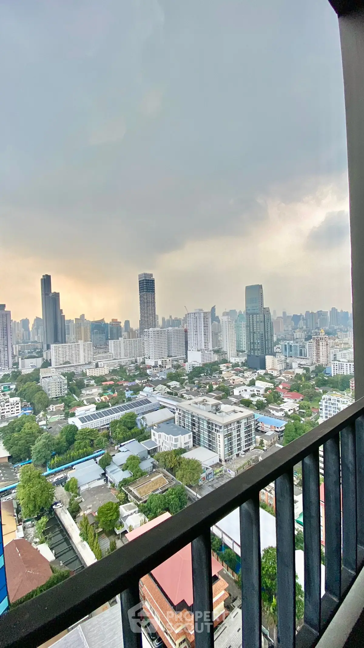 Stunning cityscape view from high-rise balcony with urban skyline