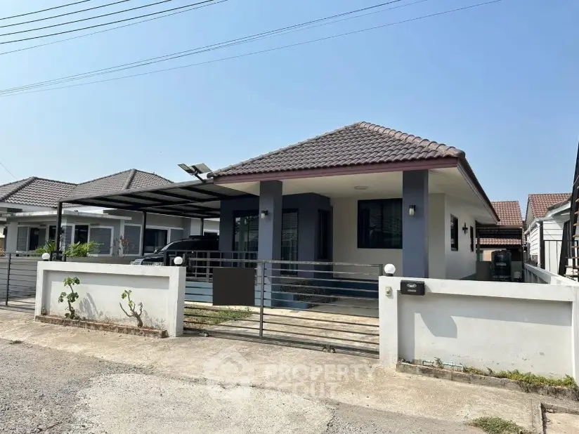 Charming single-story house with modern design and spacious driveway in a serene neighborhood.