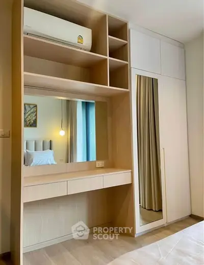 Modern bedroom with built-in wardrobe and vanity mirror