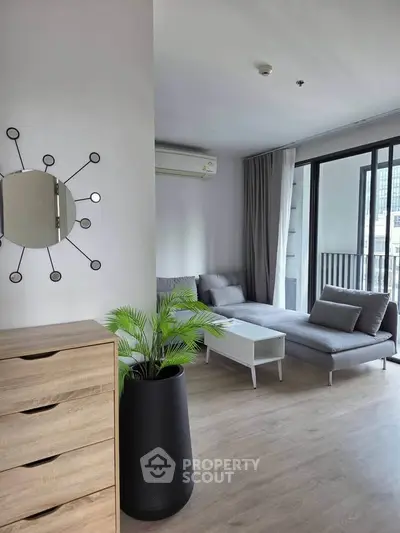Modern living room with stylish decor and large windows offering natural light