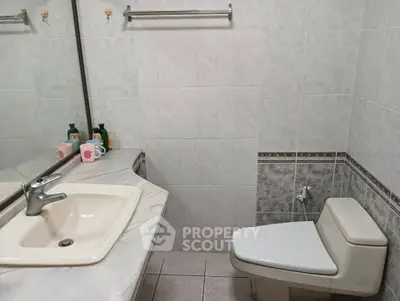 Modern bathroom with elegant marble sink and stylish tiled walls.