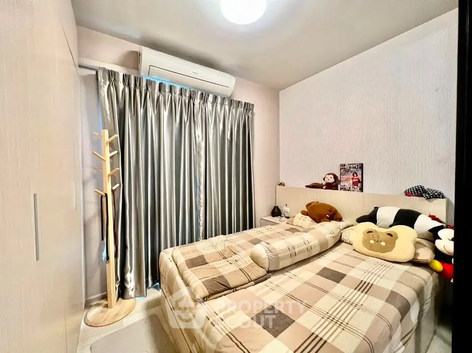 Cozy bedroom with stylish decor and ample natural light