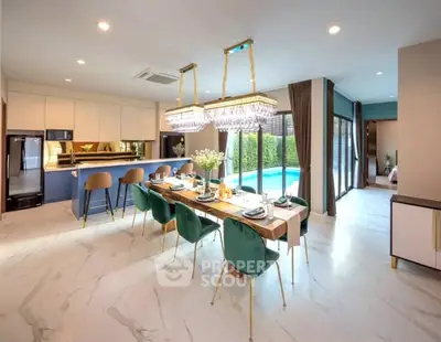 Luxurious open-plan kitchen and dining area with pool view, featuring elegant decor and modern appliances.