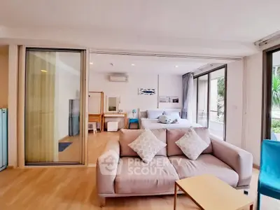 Spacious open-plan living room with cozy sofa and modern decor