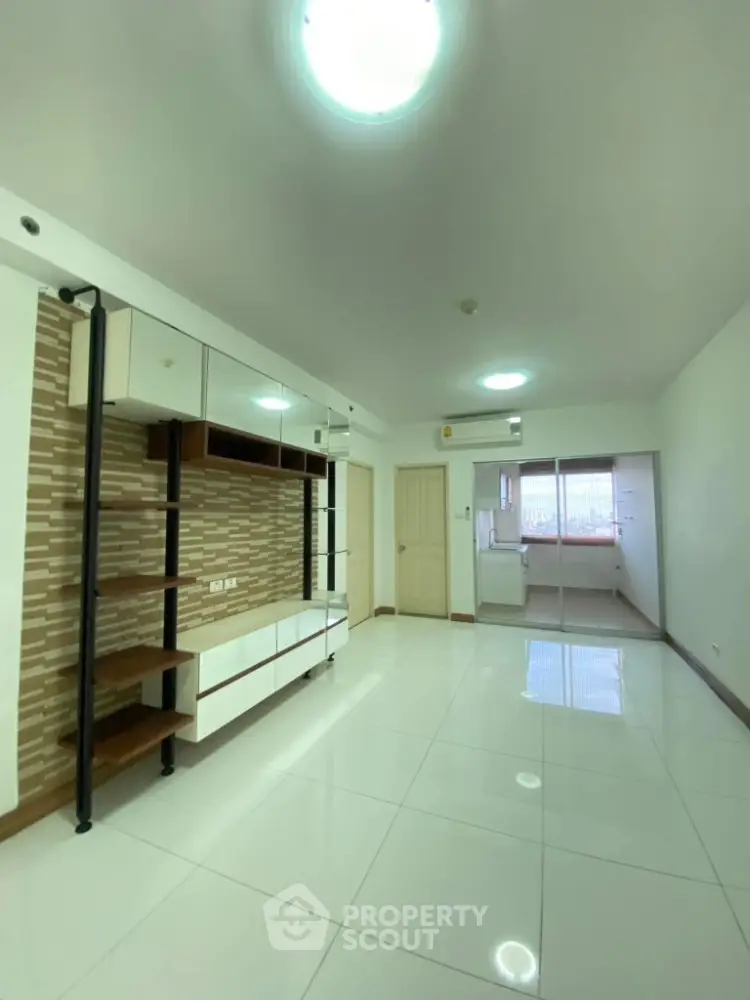 Spacious modern living room with open layout and sleek tile flooring