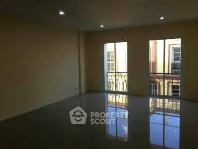 Spacious empty room with large windows and glossy tiled floor